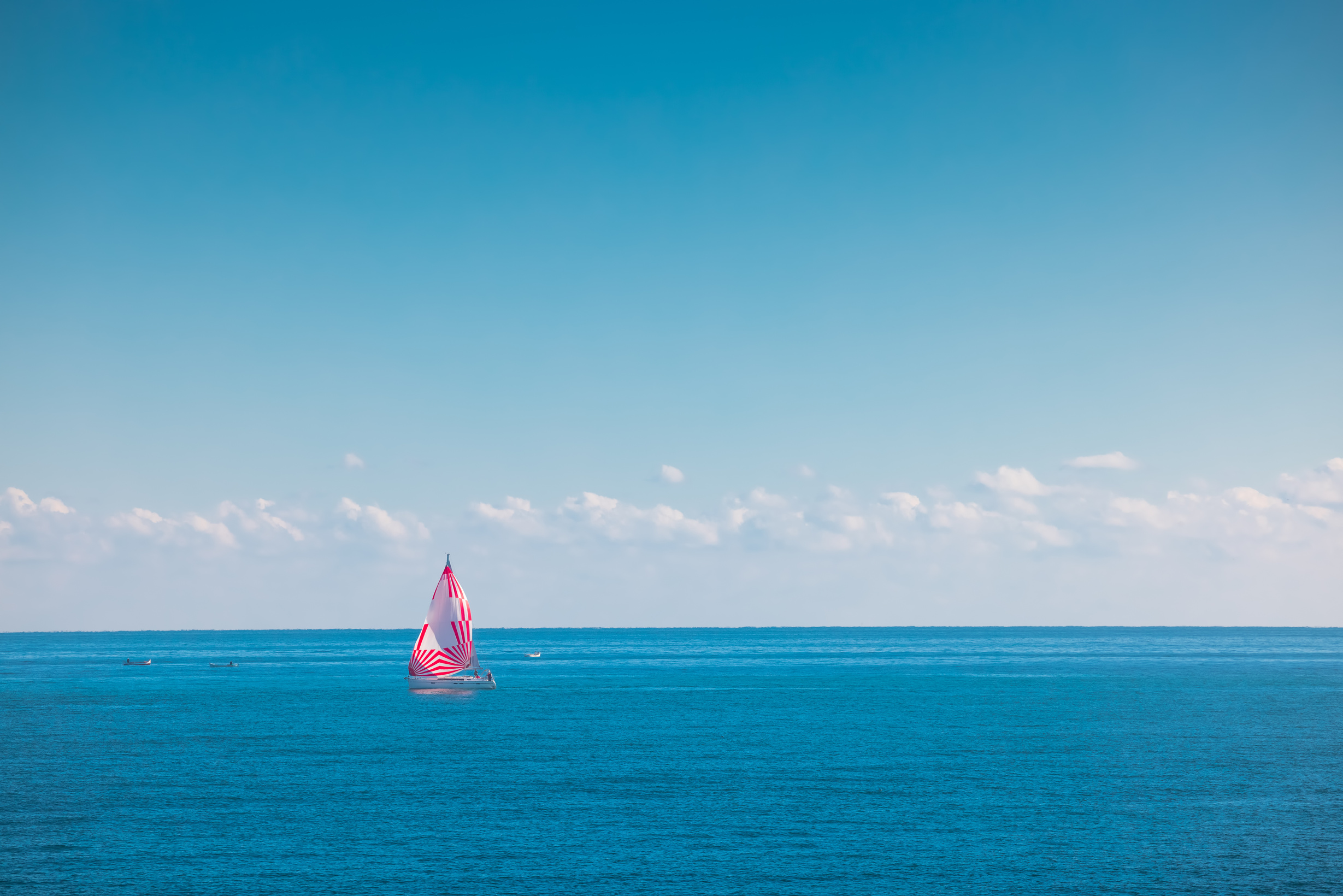 Sea and sailing wind boat. Sailboat over blue waves and sunny sky